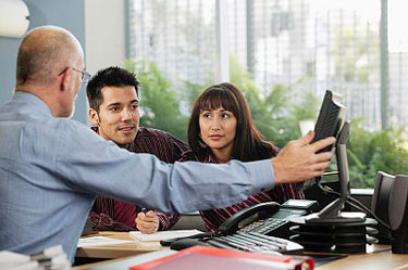 young couple getting advice from a financial counselor